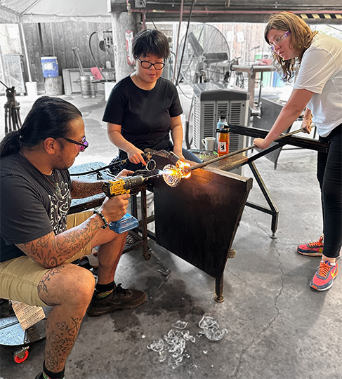 Expert artist glassblowers Manolo Santos, Rinoi Imada and Jessica Jane Julius fabricate the scent vents that allow scents to emerge from the system at the Pilchuck School.